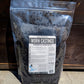 Bag of worm castings with a label on a wooden surface