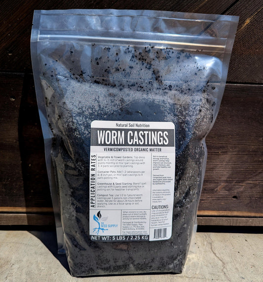Bag of worm castings with a label on a wooden surface